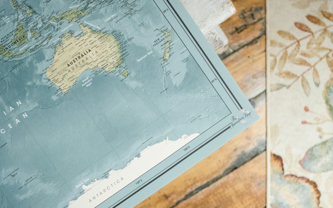 blue and white map on brown wooden table